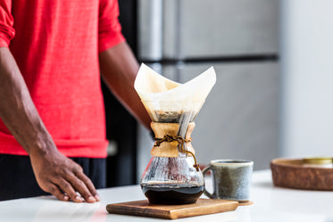 man waits for pour over coffee to brew