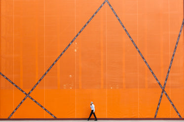 man walking by orange