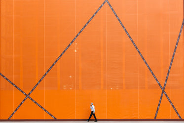 man walking by orange