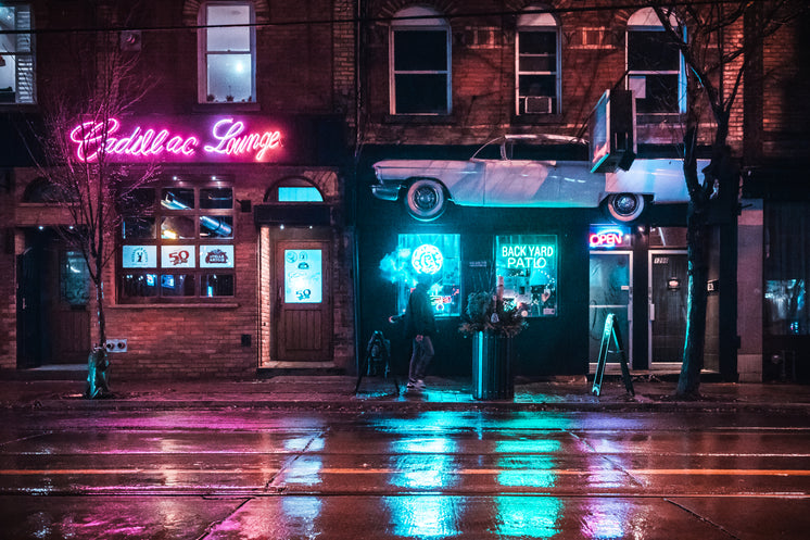 man-walking-past-bar-in-neon-light.jpg?width=746&format=pjpg&exif=0&iptc=0