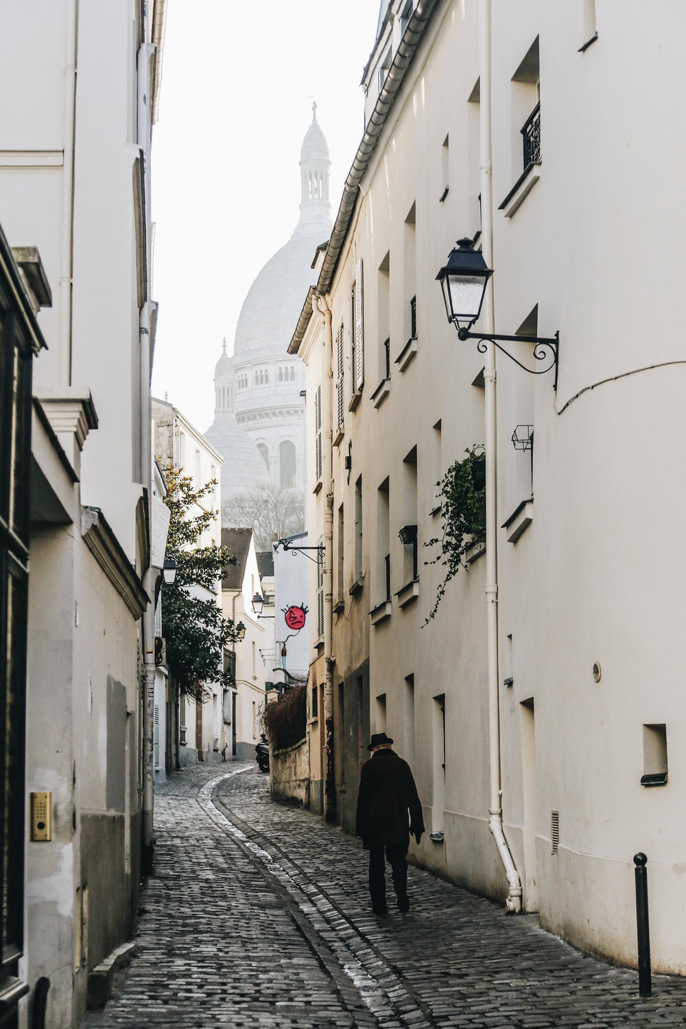 man walks on cobbled street