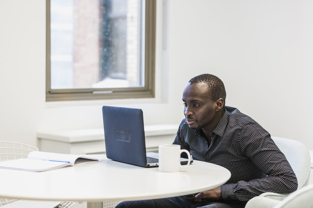 man watches laptop