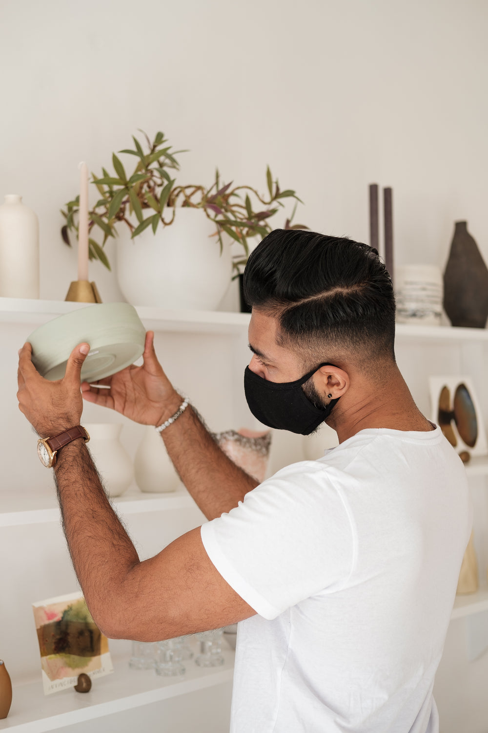 man wearing face mask inspects product in store