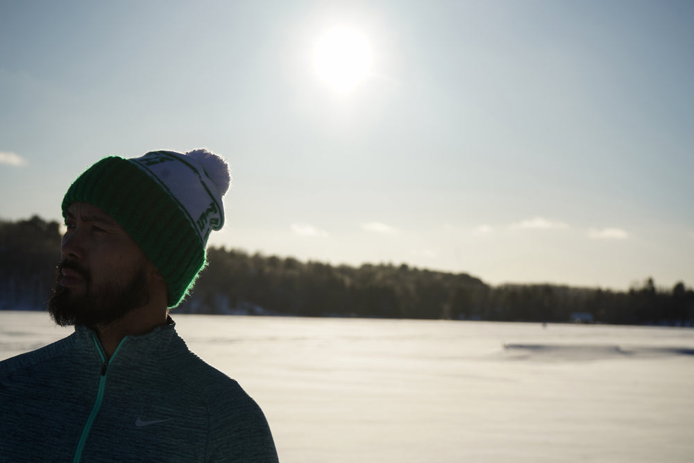 man wearing hat on sunny snow day