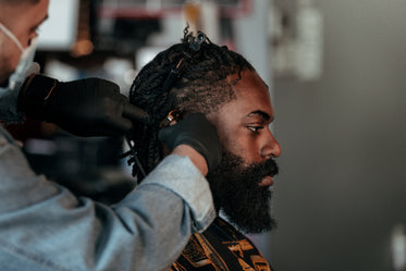 man with beard getting a trim