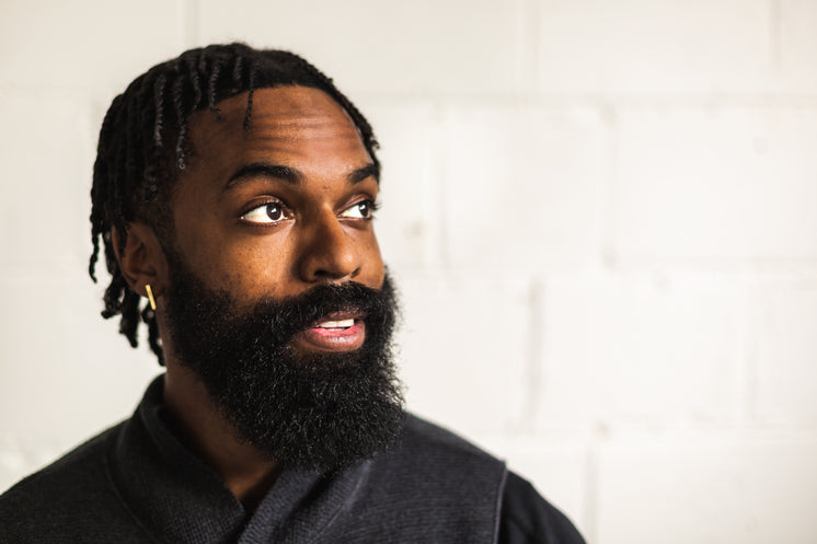 Man With Beard Looks Out Of Window