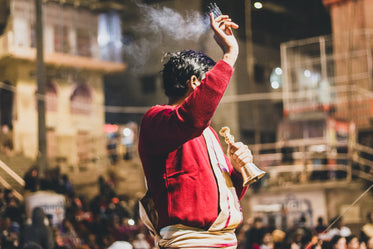 man with bell and incense