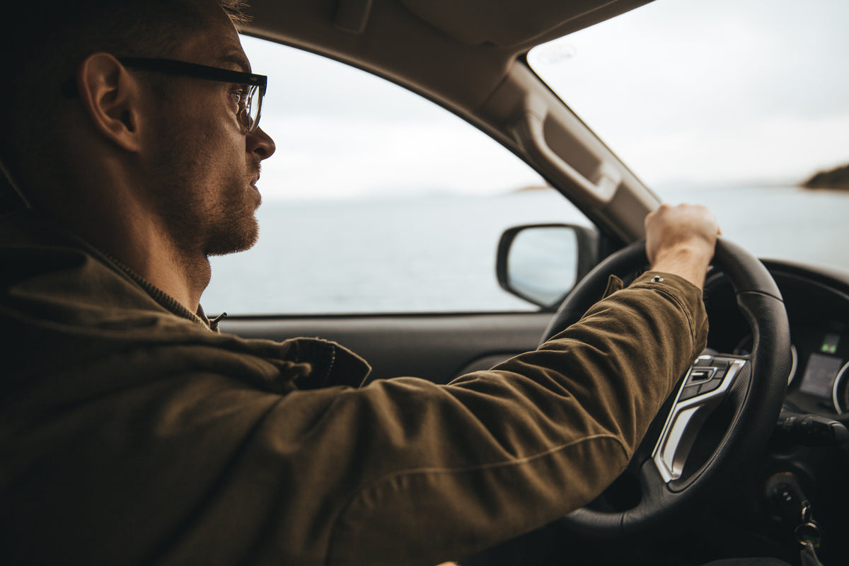 man with glasses driving