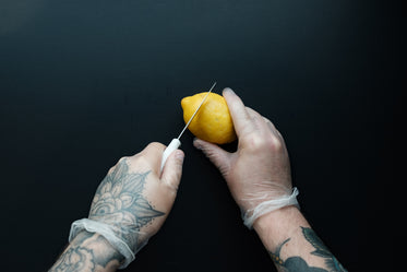 man with tattooed hands prepping food