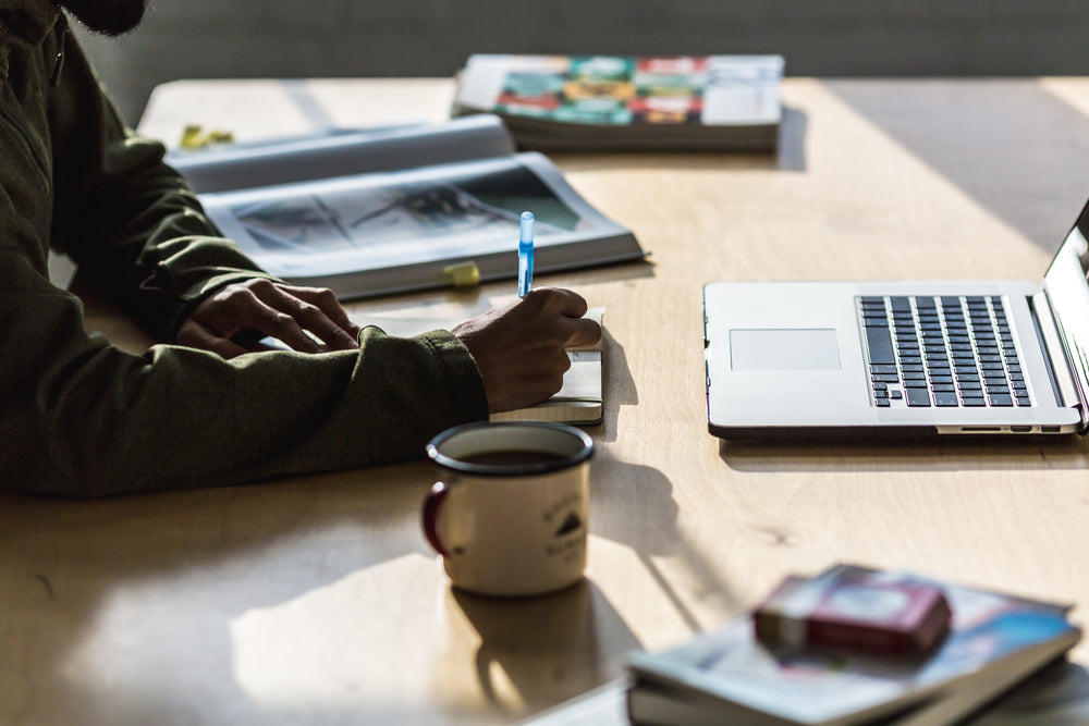 man writing at desk