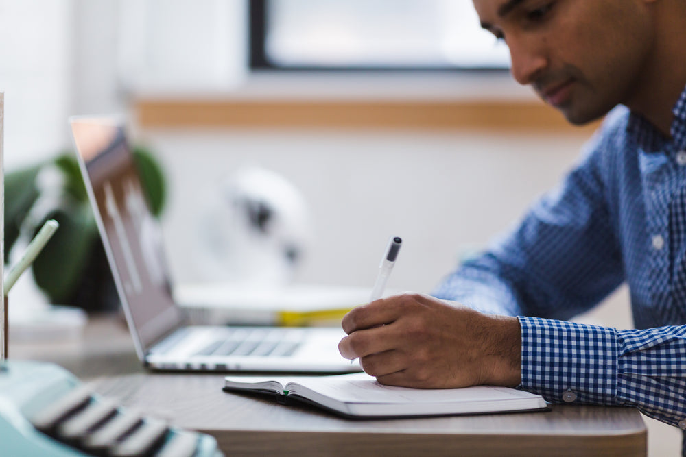 man writing notes