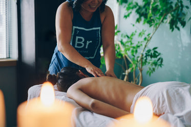 massage therapist treating woman