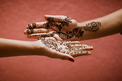 mehndi designs on a persons palms