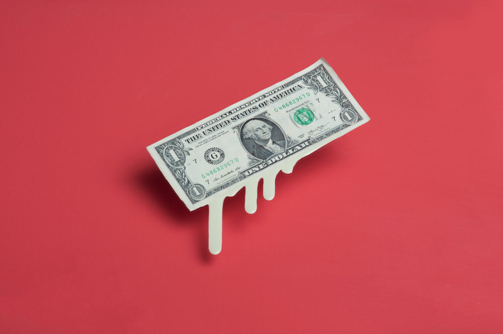 melting dollar bill money drips