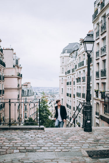 men's fashion climbing steps to cobbled street