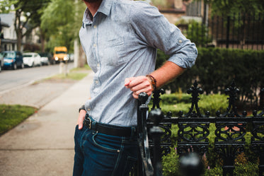 men's fashion close up shirt tucked in leaning