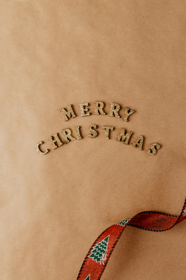 merry christmas spelled out in gold letters