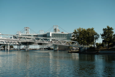 metal building and bridge on the lake