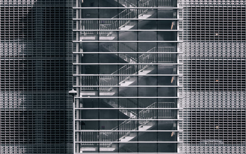 metal stairwell behind glass windows