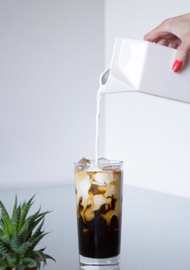 milk swirling as poured in coffee