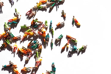 miniature figurines of people scattered on a white background