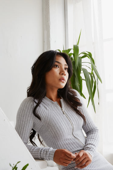 minimal portrait of woman sat on steps