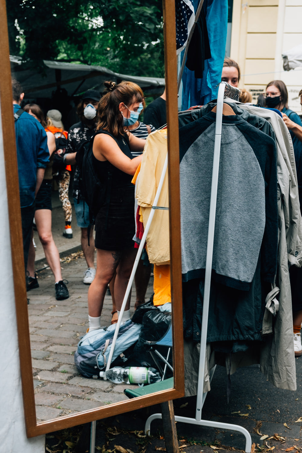 mirror reflects shoppers with face mask