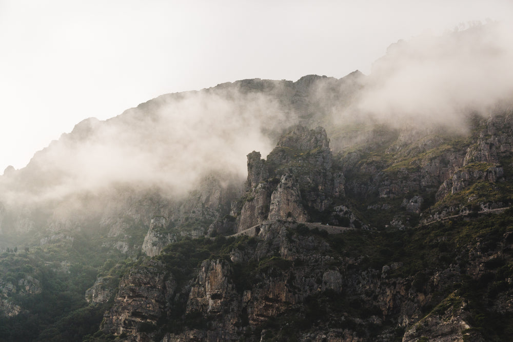 mist crawls over mountain