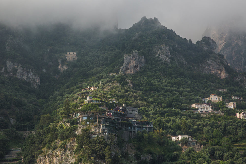 misty mountains with buildings