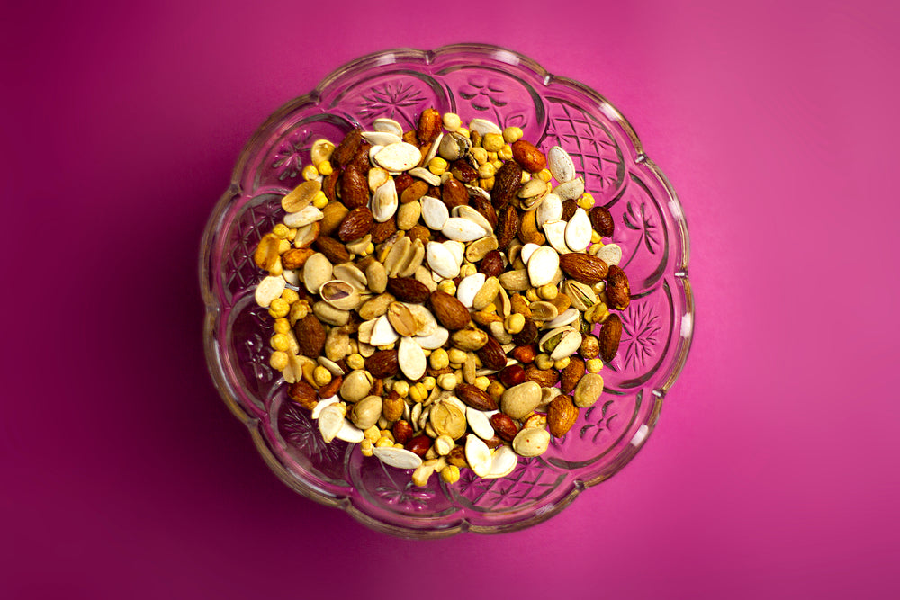 mixed nuts on pink background
