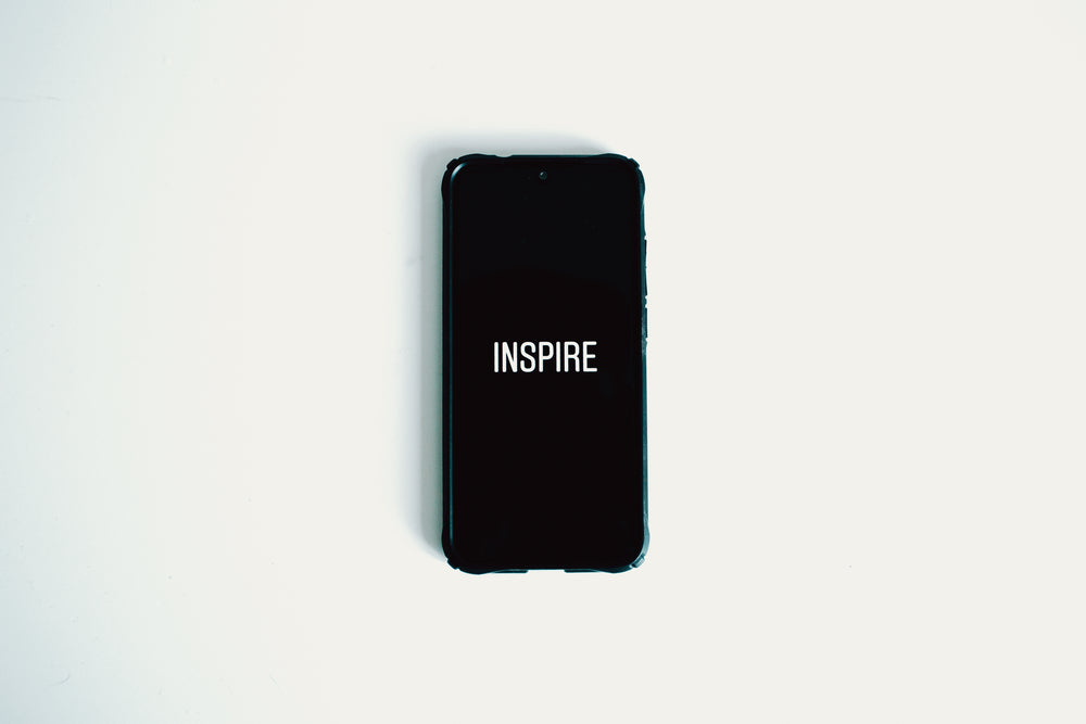 mobile phone with the words inspire on screen