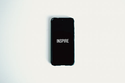 mobile phone with the words inspire on screen