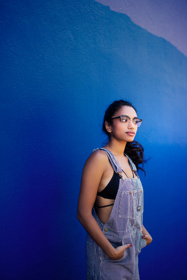 model in glasses and overalls