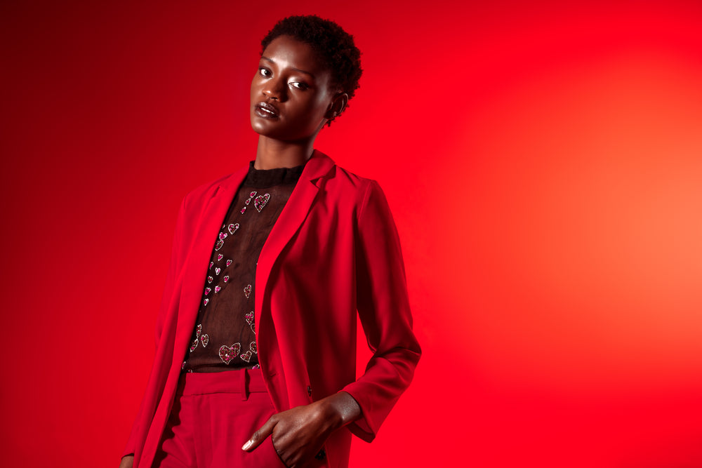 model in red suit with sheer top