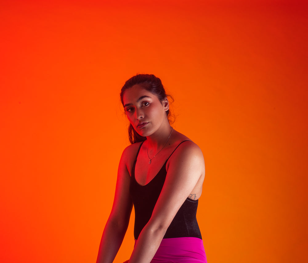 model poses against orange background