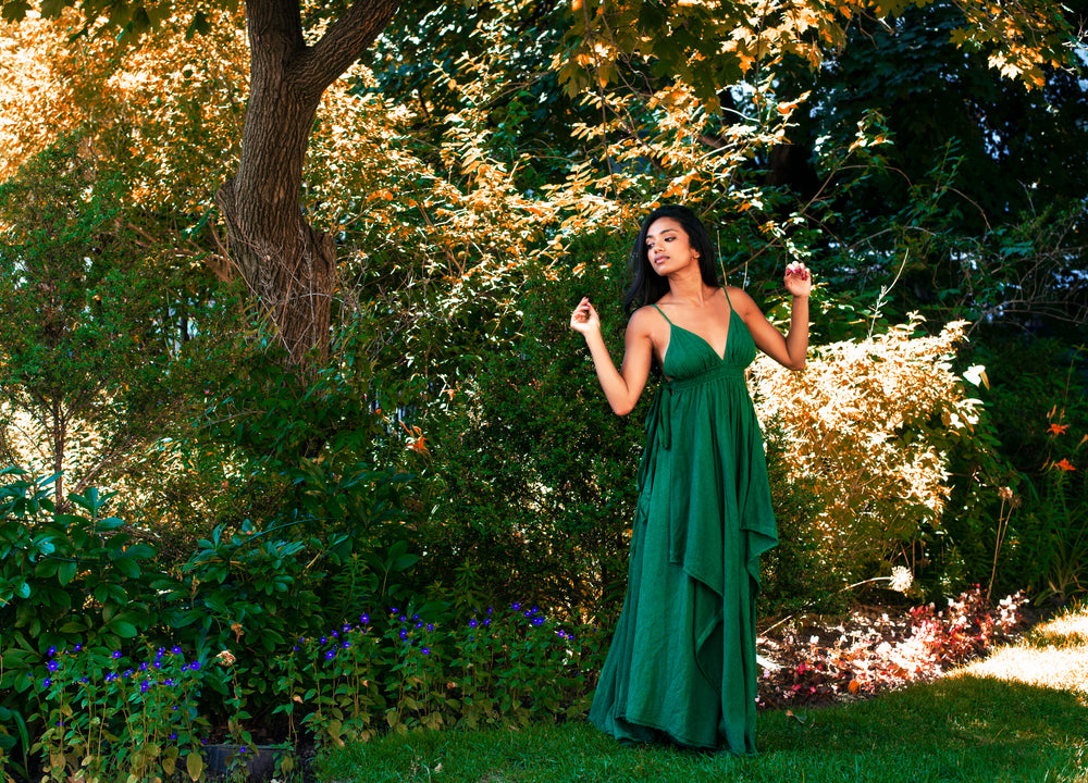 model poses in long green maxi dress