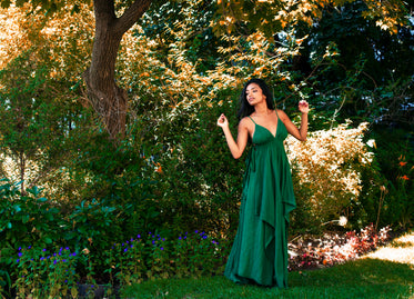 model poses in long green maxi dress