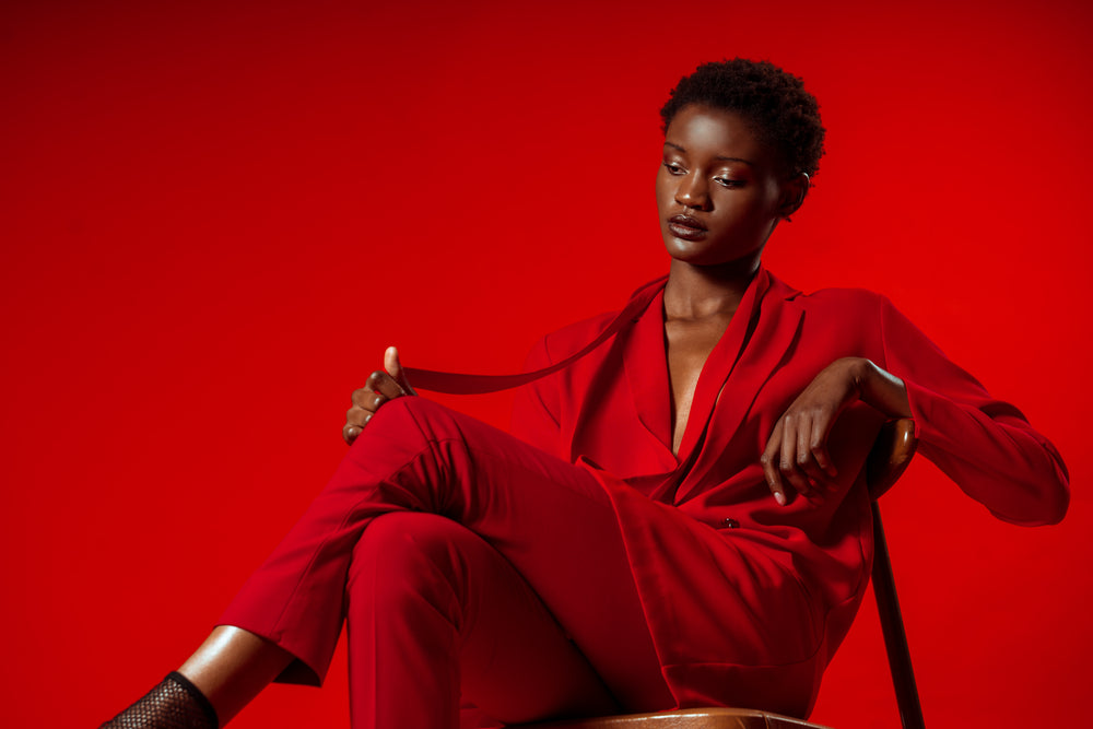 model poses in red pansuit