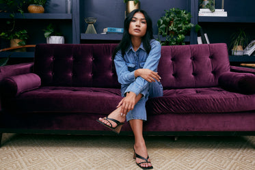 model posing on purple velvet couch