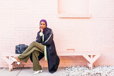 model rests on bench showing off her spring style