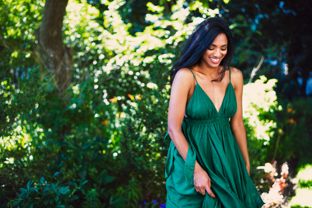 model smiles and walks in green dress