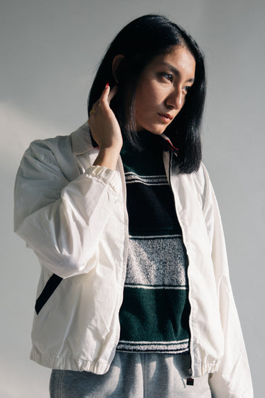 model stares through a nearby window