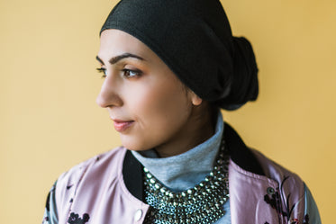 model wearing a chunky necklace and pastel jacket