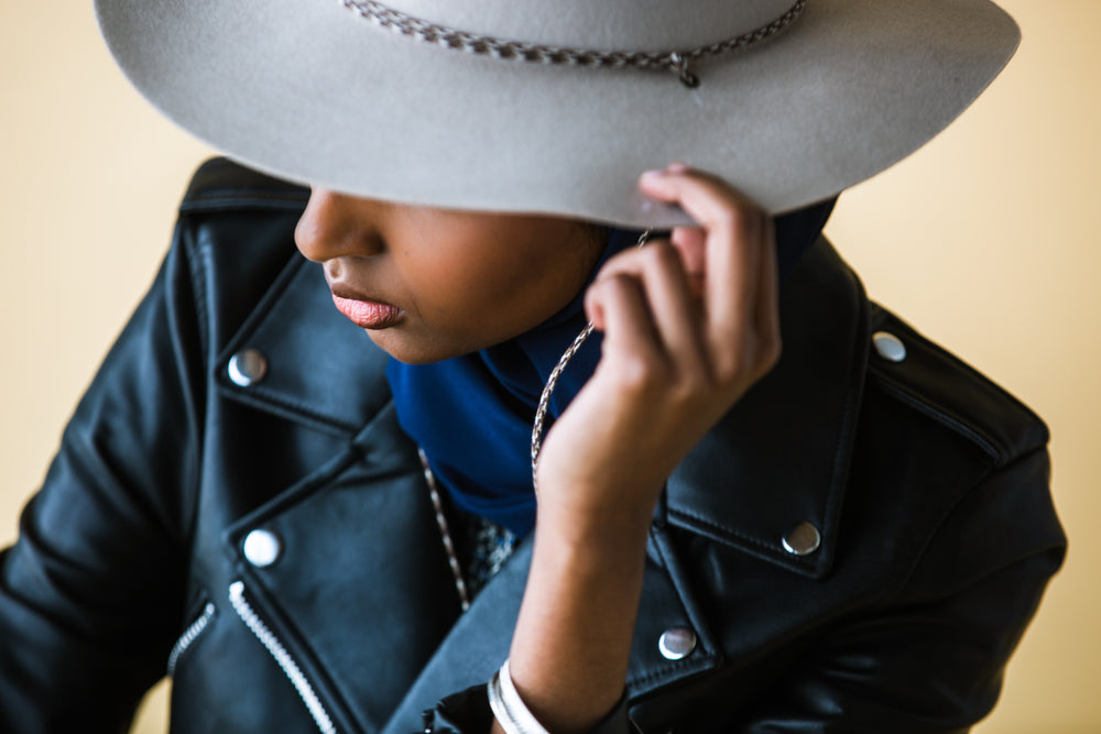 model wearing a gray hat and leather jacket