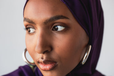 model wearing thick silver hoop earrings