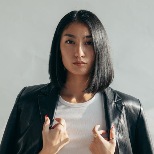 Model With Leather Jacket Over Shoulders