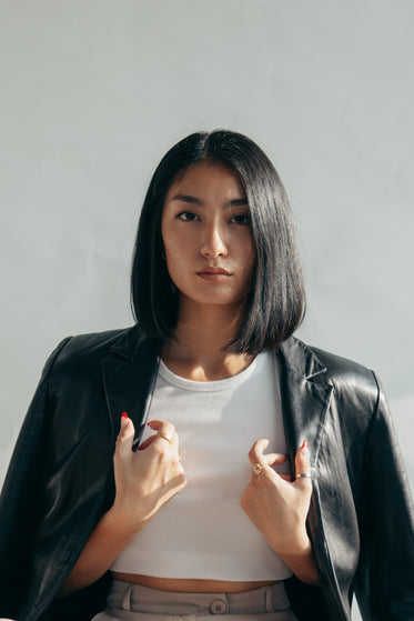 model with leather jacket over shoulders
