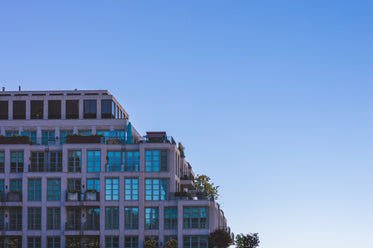 modern condo building under bright blue sky
