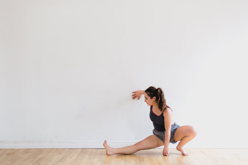 A modern dancer stretching before rehearsal