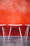 modern stools by red wall